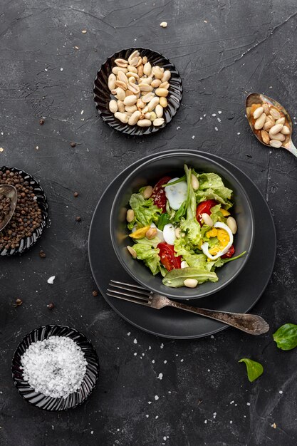 Top view homemade salad on dark background