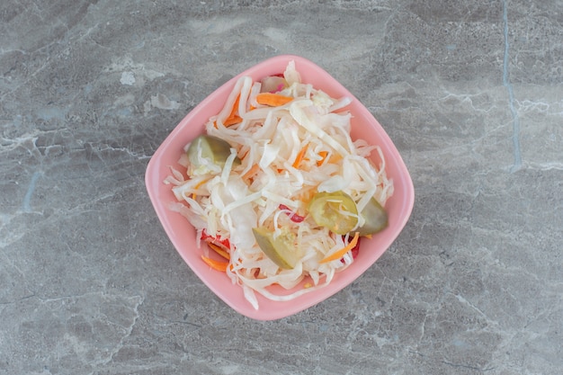 Free photo top view of homemade sauerkraut in pink bowl.