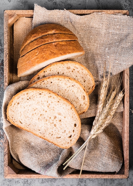 Top view homemade slices of bread and wheat