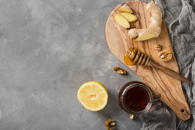 Free photo top view honey jar with food and honeyspoon