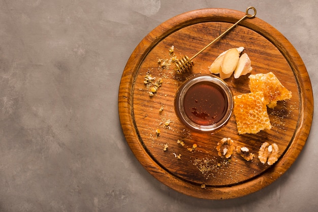 Top view honey jar with food and honeyspoon