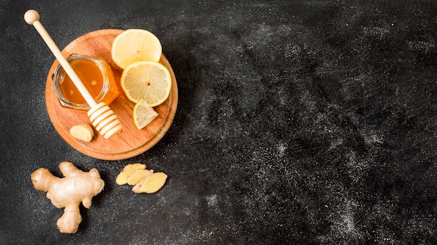 Top view honey jar with ginger and lemon