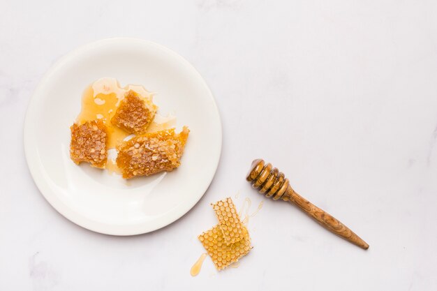 Top view honey spoon with honeycomb pieces