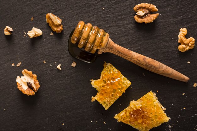 Top view honey spoon with honeycomb pieces