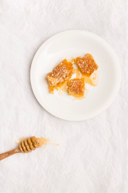 Top view honey spoon with honeycomb pieces