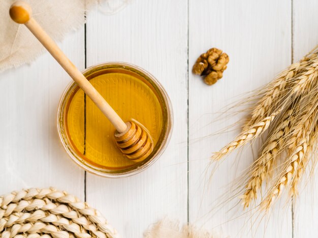 Top view honey next to wheat