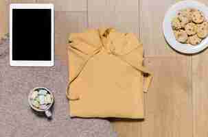 Free photo top view hoodie with tablet beside