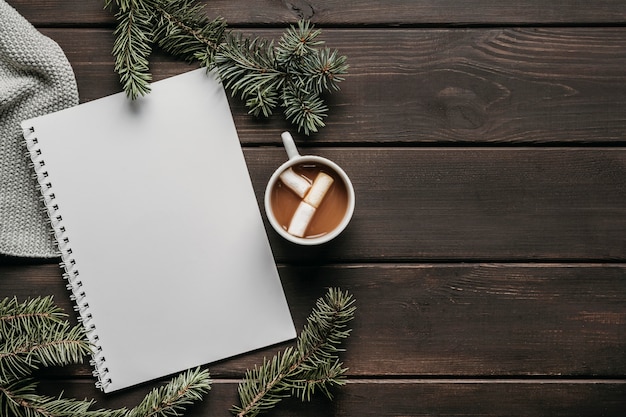 Top view hot chocolate with blank notebook and copy-space