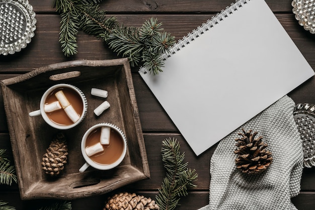 Top view hot chocolate with blank notebook