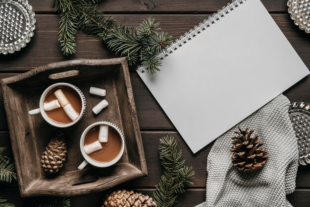 Top view hot chocolate with blank notebook