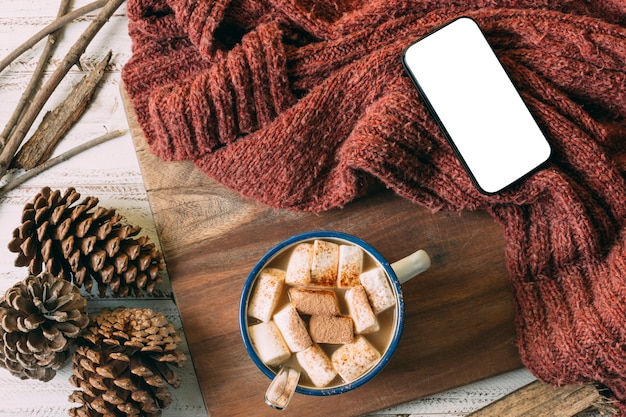 Top view hot chocolate with mock-up phone