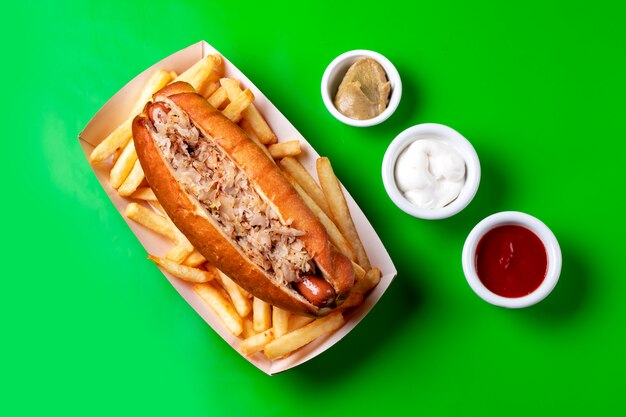 Top view of hot dog with tuna served with french fries mayonnaise ketchup and mustard