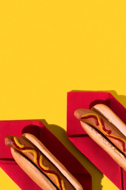 Top view hot dogs on red napkins copy space