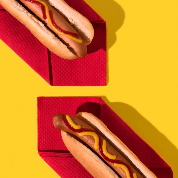 Top view hot dogs on red napkins