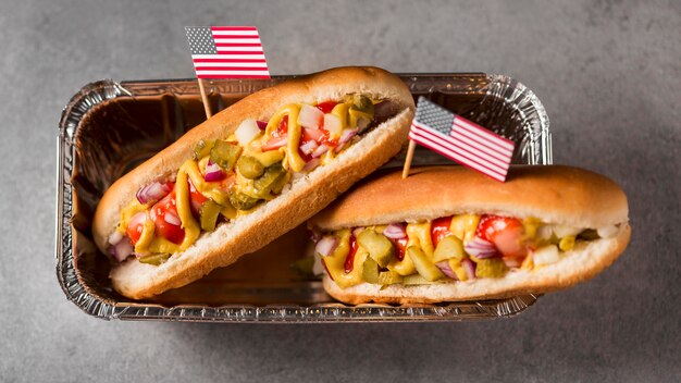 Top view hot-dogs with american flag in tray