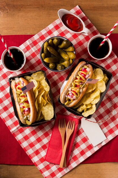 Top view hot-dogs with chips and pickles