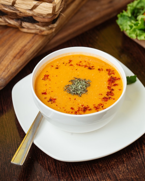 Free photo a top view hot soup with dried mint inside white plate on the wooden desk food soup meal