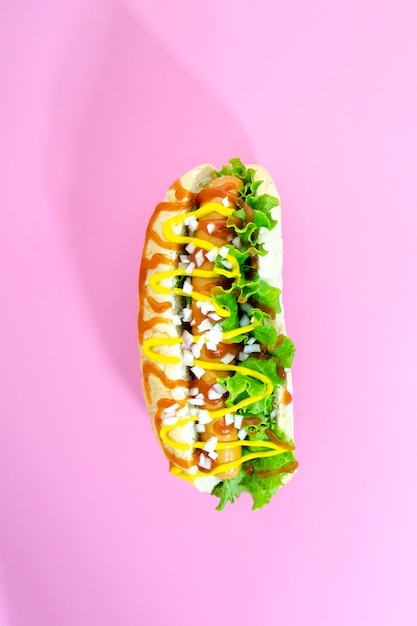 Top view of hotdog with onion and lettuce