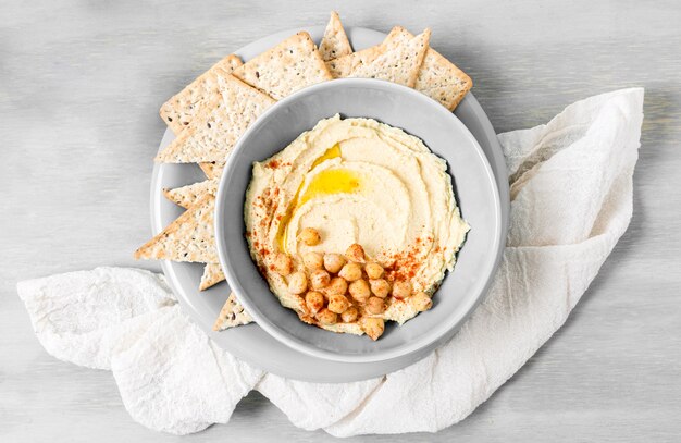 Top view of hummus with chickpeas and nacho chips