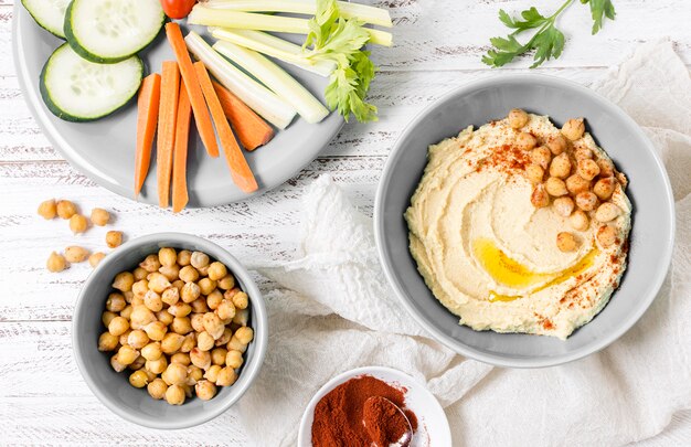 Top view of hummus with chickpeas and vegetables