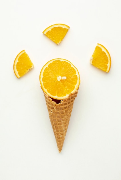 Free photo top view ice cream cone with orange