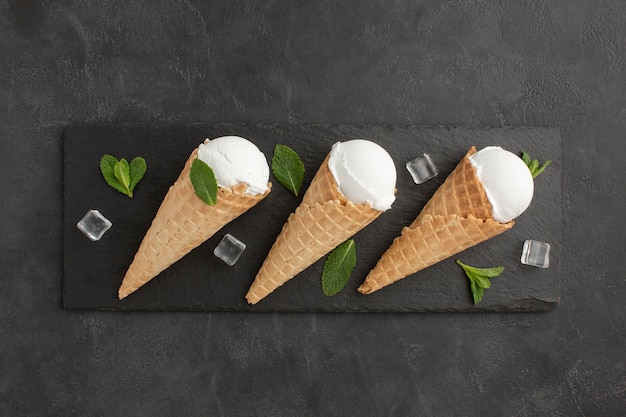 Top view ice cream on cones with ice cubes