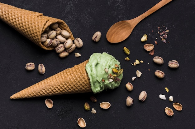 Free photo top view ice cream cones with pistachio