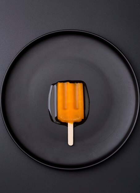 Top view ice cream on stick on plate