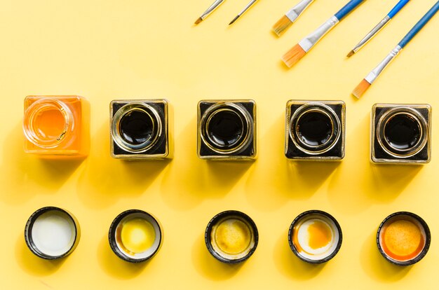 Top view ink jar line with brushes