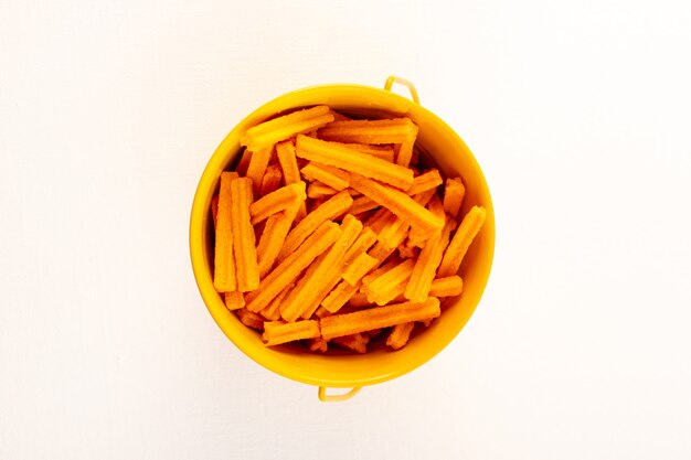 A top view italian dry pasta raw orangepasta inside bowl on the white