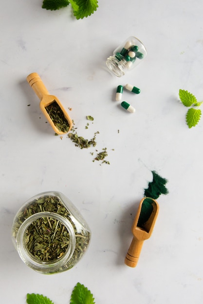 Free photo top view jar with herbs and capsules on the table