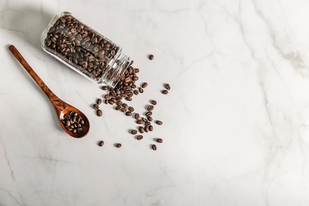 Top view of jar with roasted coffee beans and copy space