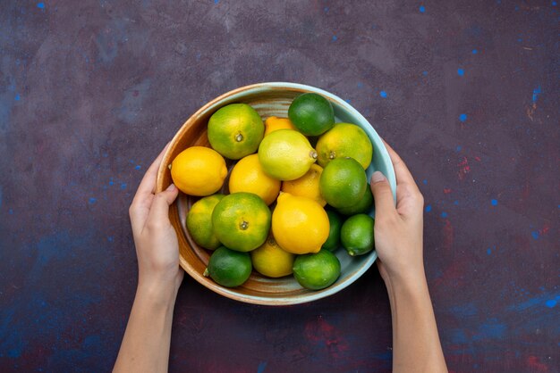 Top view juicy fresh citruses lemons and tangerines on dark desk citrus tropical exotic orange fruit