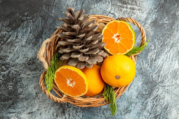 Top view of juicy fresh tangerines inside basket on light-grey surface