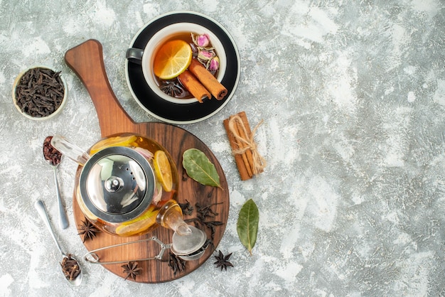 Top view kettle with tea lemon tea on light background flower color morning breakfast food fruit flavor ceremony