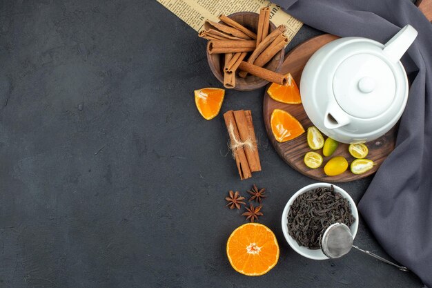 Top view kettle with tea with cinnamon and fresh black tea on dark background color table morning breakfast coffee photo meal egg food