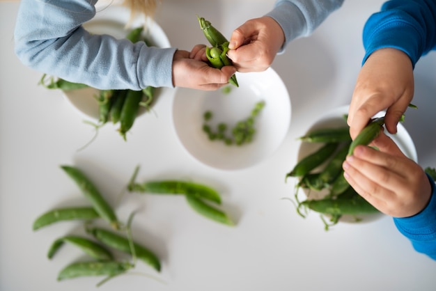 Top view kids holding green beans