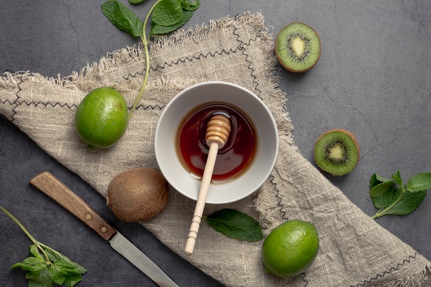 Free photo top view of kiwi and bowl of honey