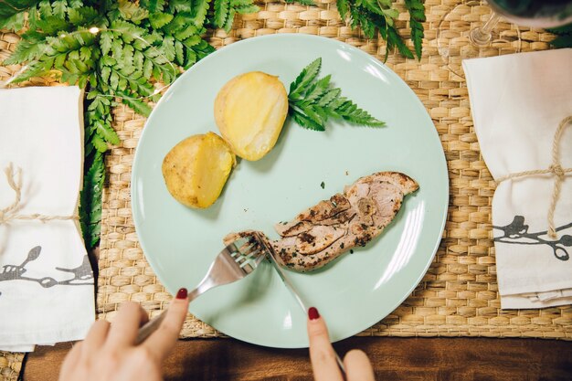 Top view of knife cutting meat