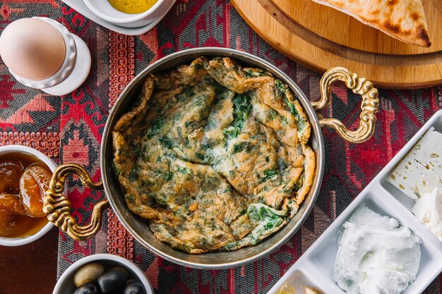 Top view kyukyu omelet with herbs in a pan