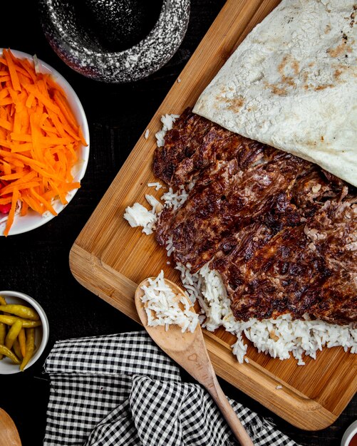 Top view of lamb kebab doner placed on rice