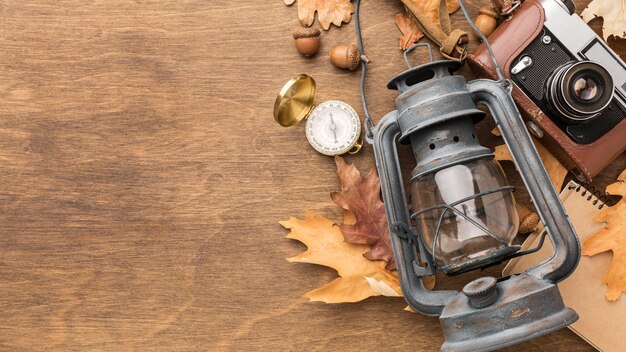 Top view of lantern with camera and autumn leaves