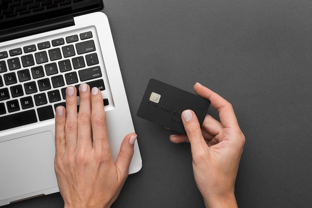 Top view laptop and black shopping card