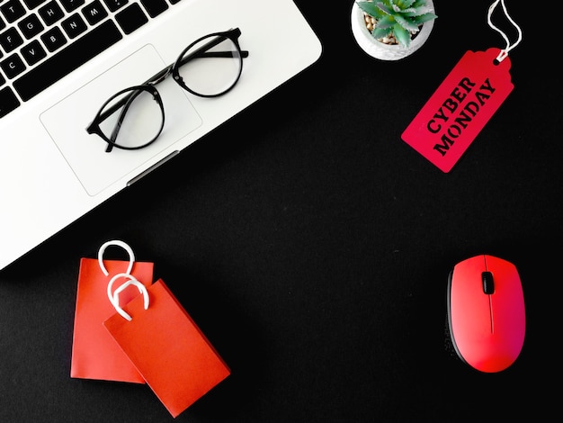 Top view of laptop and mouse with tag for cyber monday