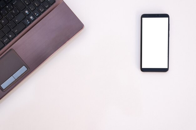 Top view of laptop and smartphone isolated on a white surface