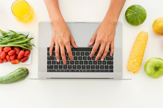 Top view laptop surrounded by fruit