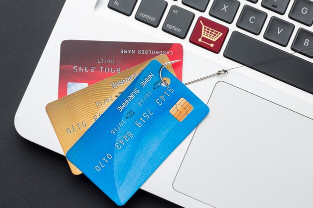 top view of laptop with credit card and phishing hook