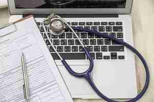 Free photo top view of laptop with stethoscope