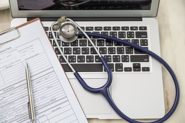 Top view of laptop with stethoscope