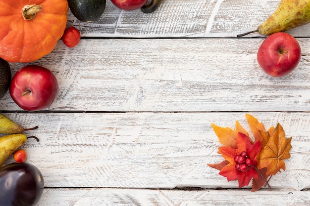 Free photo top view leaves and fruits with copy space